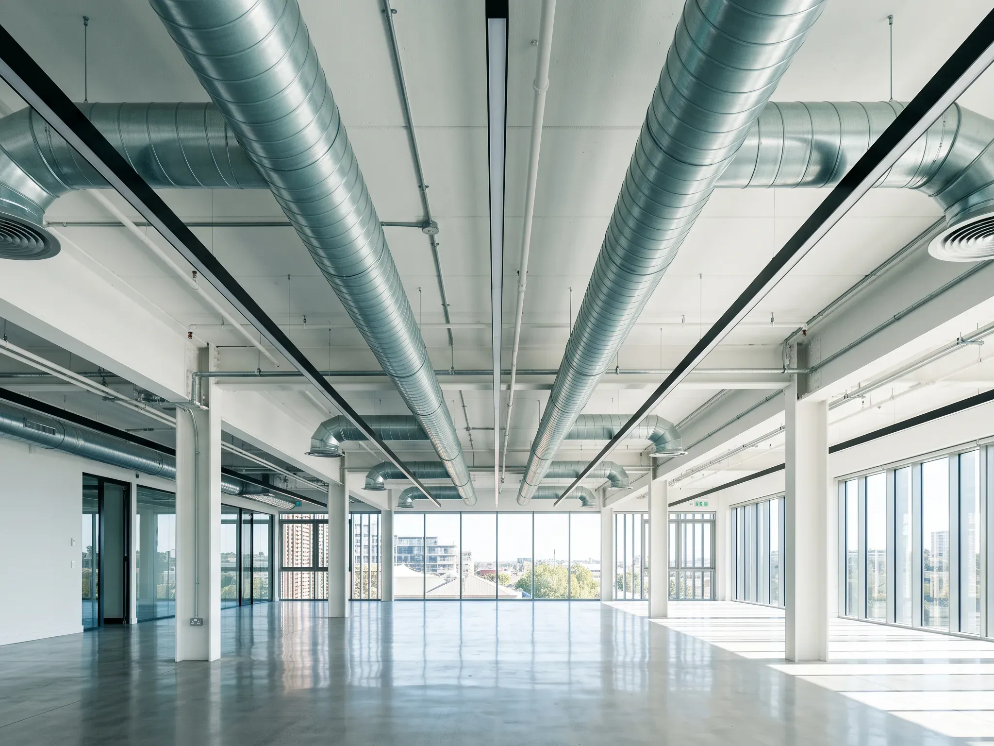 Commercial ceiling with spiral ductwork, linear lights and sprinkler lines