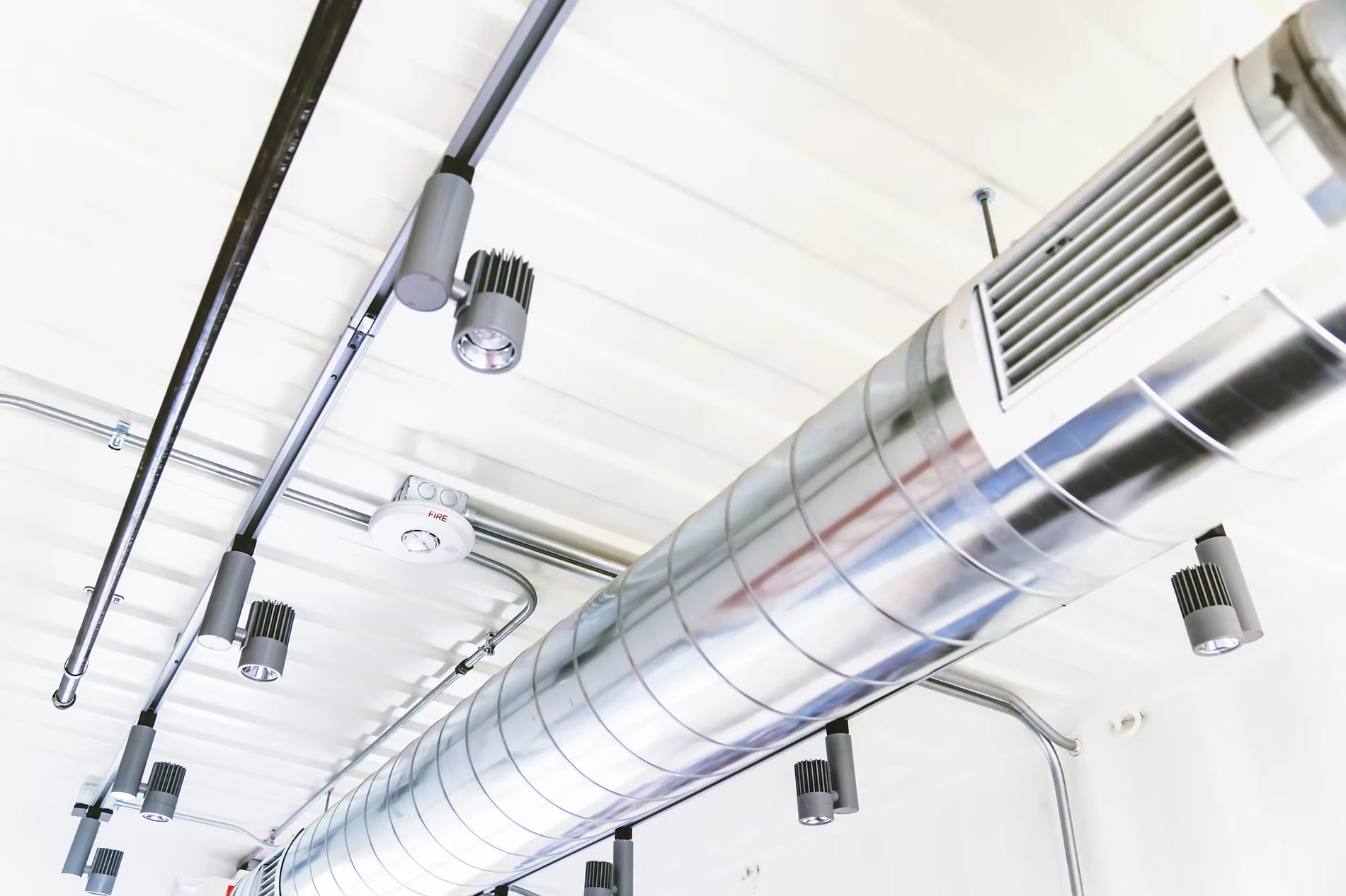 Exposed mechanical ductwork across a ceiling
