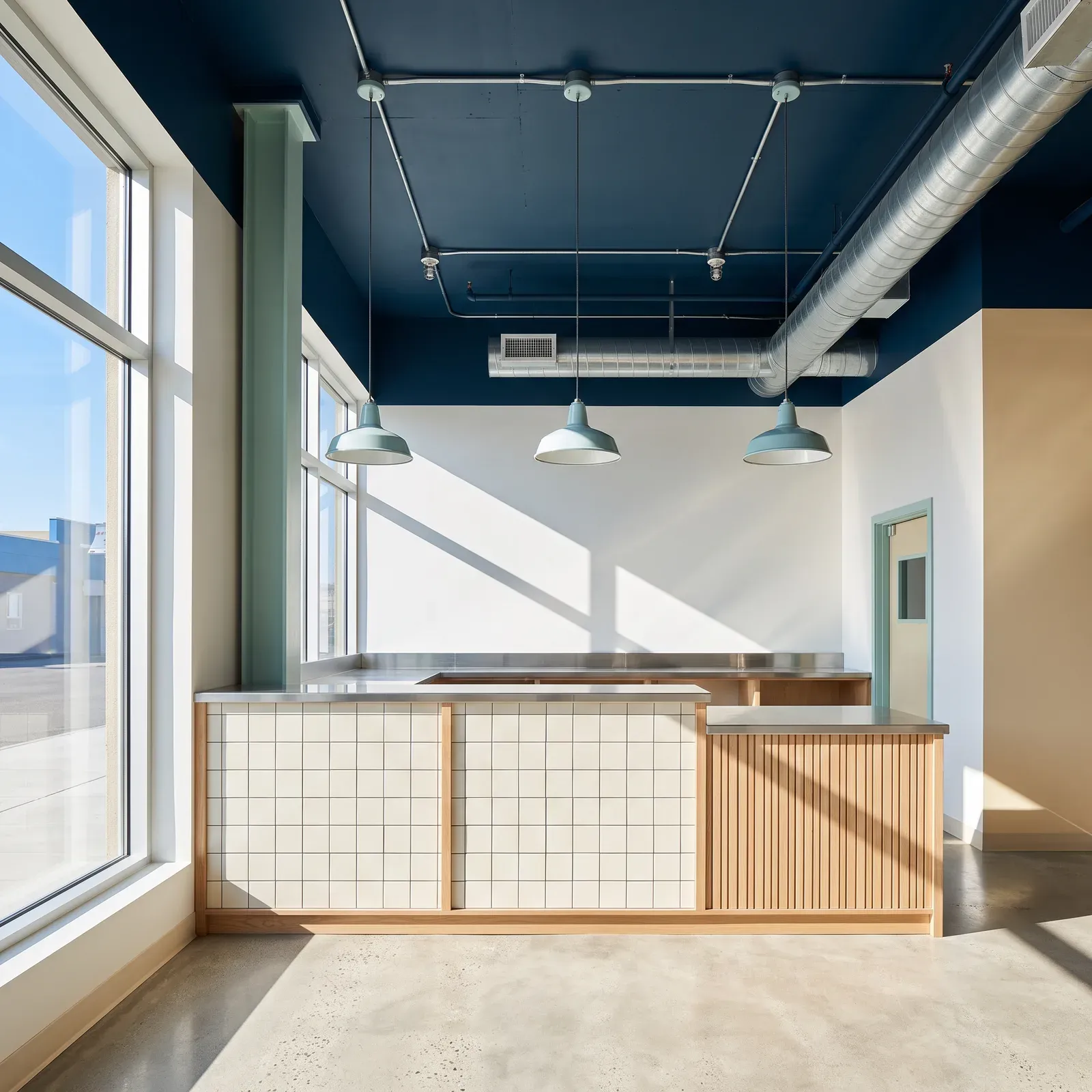 Café counter in a former office unit under an exposed blue ceiling